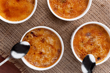 Creme brulee in a white bowl with sugar crust. Studio photography. country style.