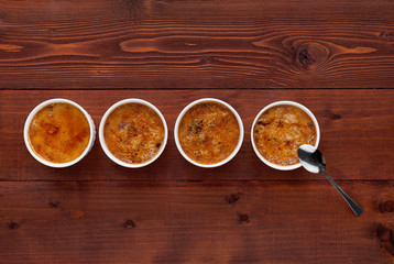 Creme brulee in a white bowl with sugar crust. Studio photography. country style.