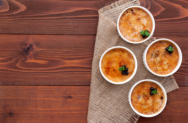 Creme brulee in a white bowl with sugar crust. Studio photography. country style.