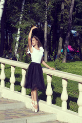 Girl is engaged in a ballet in the park 