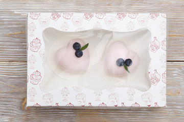 Two pink mini cakes in a gift box