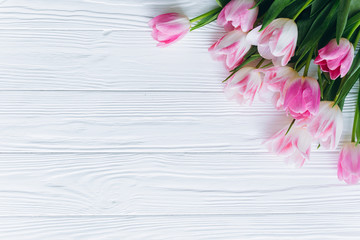 Wooden white background and pink tulips. Conception holiday, March 8, Mother's Day.