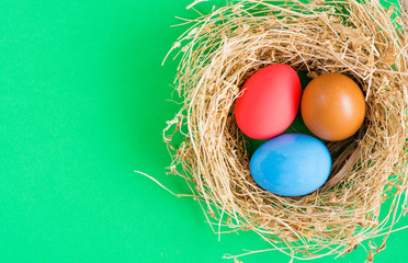Easter eggs in nest on rustic wooden background, selective focus image. Happy Easter Card - space for text 