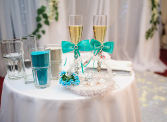 two glasses with champagne and other attributes for the wedding ceremony