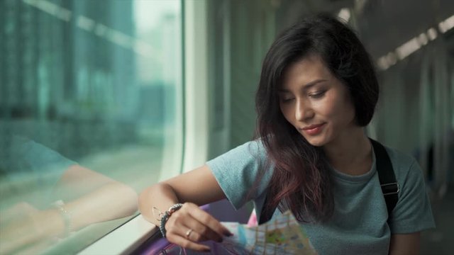 girl travelling in subway and checking map