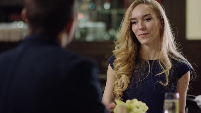 beautiful blondie talking with her partner in restaurant