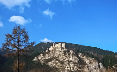 Castle on the rock in colorful woods during autumn. Slovakia
