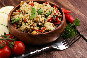 Delicious vegetarian quinoa salad with bell pepper, cucumber and tomatoes