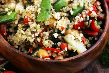 Delicious vegetarian quinoa salad with bell pepper, cucumber and tomatoes