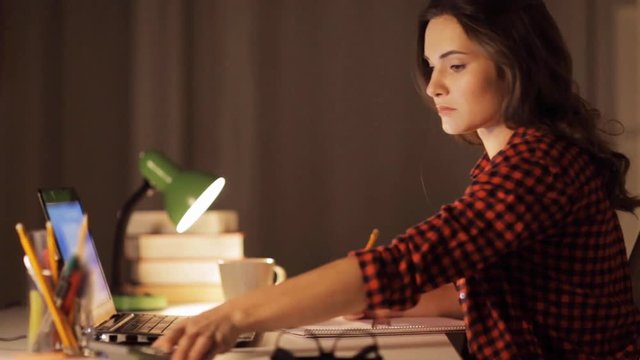 student girl with notebook and calculator at home