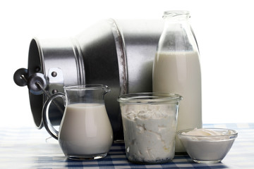 milk products - tasty healthy dairy products on a table on: sour cream in a white bowl, cottage cheese bowl, cream in a a bank and milk jar, glass bottle and in a glass