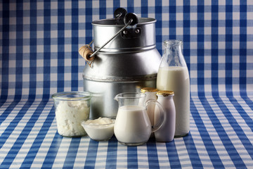 milk products - tasty healthy dairy products on a table on: sour cream in a white bowl, cottage cheese bowl, cream in a a bank and milk jar, glass bottle and in a glass