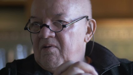 Closeup of an elderly gentleman shaking his head and saying no