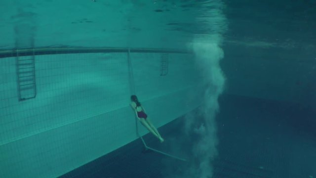 Diving (Jumping into the water), female athlete entry into the water, view underwater.
