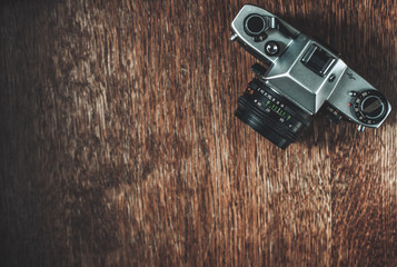 Retro camera on wooden table