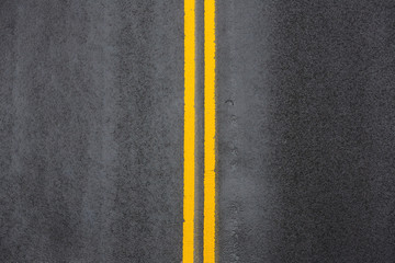 Yellow double solid line on asphalt