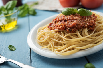 Traditional Italian spaghetti bolognese on wooden background