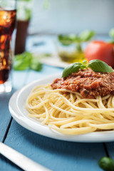 Traditional Italian spaghetti bolognese on wooden background