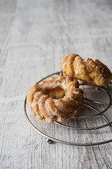 Sweet donuts with icing on wooden background