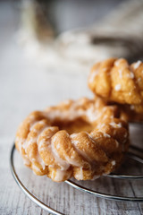 Sweet donuts with icing on wooden background