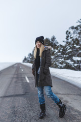Girl is standing on the winter road