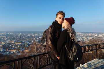 Young hipster couple in love with black dress walking in the city and embrace