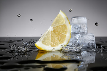 Lemon with water drops and ice cubes