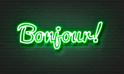 Bojour neon sign on brick wall background.