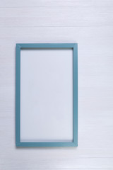 Blank photo frame on white wood background. Painted scraped wooden planks texture or pattern.