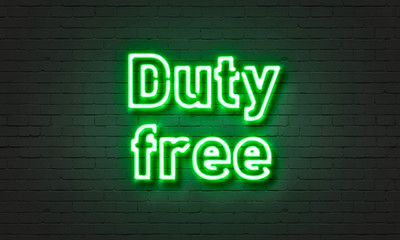 Duty free neon sign on brick wall background.