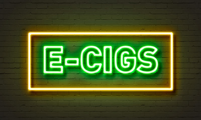 E-cigs neon sign on brick wall background.