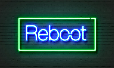 Reboot neon sign on brick wall background. - obrazy, fototapety, plakaty
