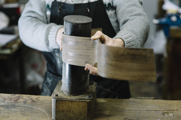 Man working at a Workshop with Musical instruments