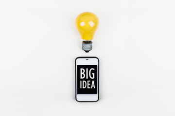 idea concept with light bulbs and smartphone,cell phone with motivation text