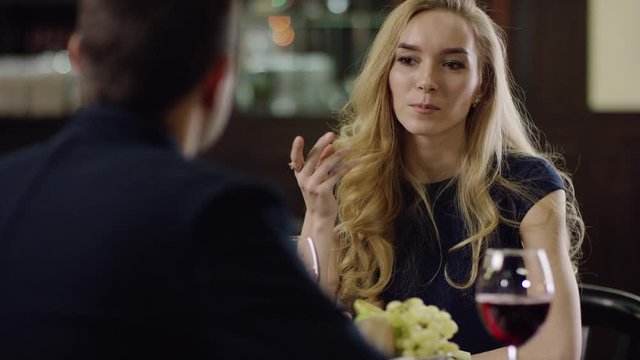 beautiful blondie telling to partner in restaurant