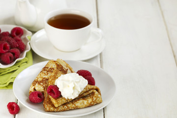Crepes with raspberries and whipped cream