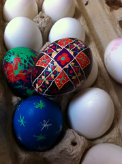 A Child's Easter Pysanka Resting on top of an Egg Carton