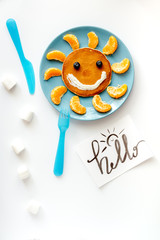 concept kid breakfast with pancake top view on white background