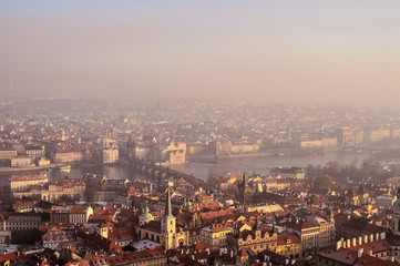 Aerial view to Prague buildings and the city from Prague Castle on a foggy day.