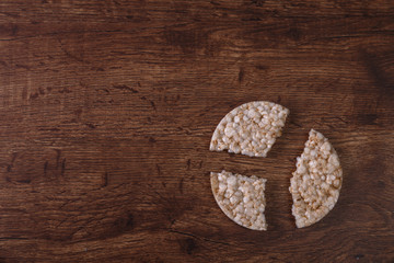 Rice biscuits on grunge rustic wood background. Natural organic diet food. Wooden vintage board.