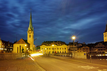 Night photo of Fraumunster Church and bridge over Limmat River, city of Zurich, Switzerland