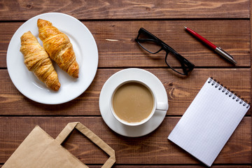 Business breakfast with coffee and croussant top view