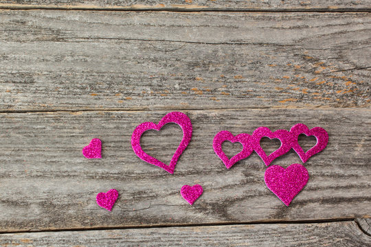 pink valentines on a rustic wood background