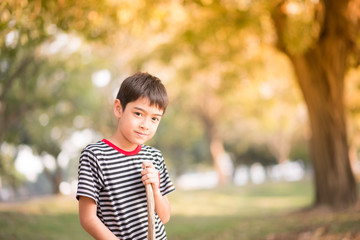 Close up asian boy sitting in th park