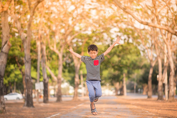 Little boy running in the park with happy face