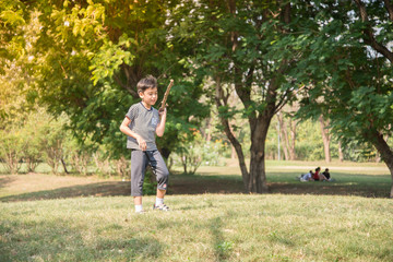 Little boy playing tic tac toe game in the park