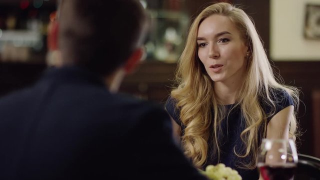 blondie telling story to partner in restaurant