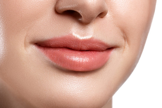 Perfect natural lip makeup. Close up macro photo with beautiful female mouth. Plump full lips.