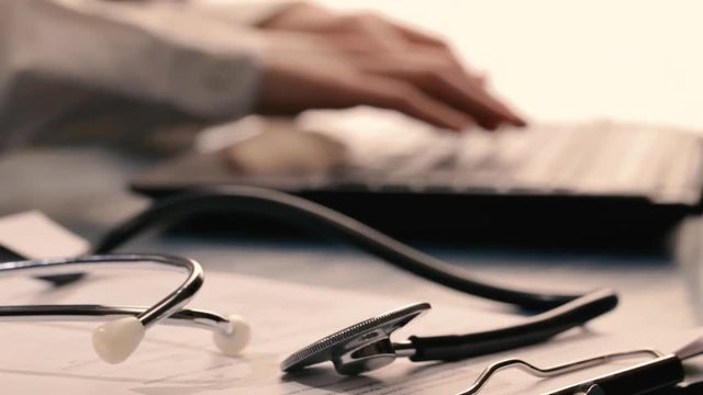 doctor type a recipe on the laptop computer keyboard. Panacea life save, prescribing treatment, legal drug store, take stock, consumption statistics concept