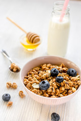 Healthy morning with granola breakfast on white kitchen table